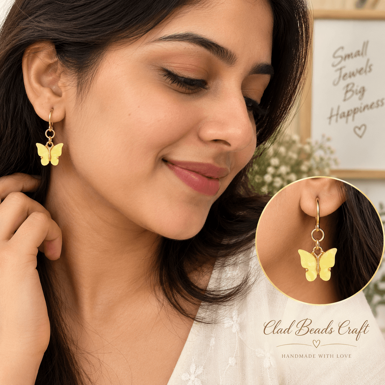 Woman wearing yellow butterfly dangle earrings with gold-tone hoops